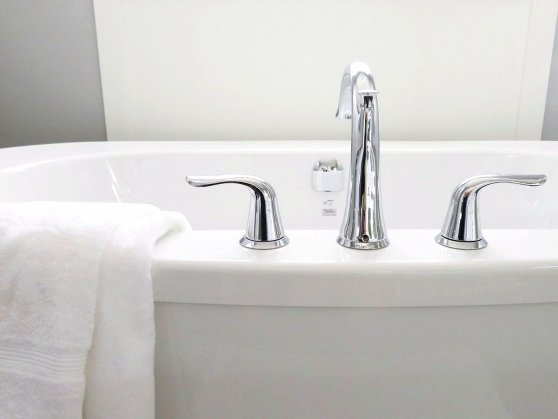 Fresh white bathtub with chrome fixtures left spotless